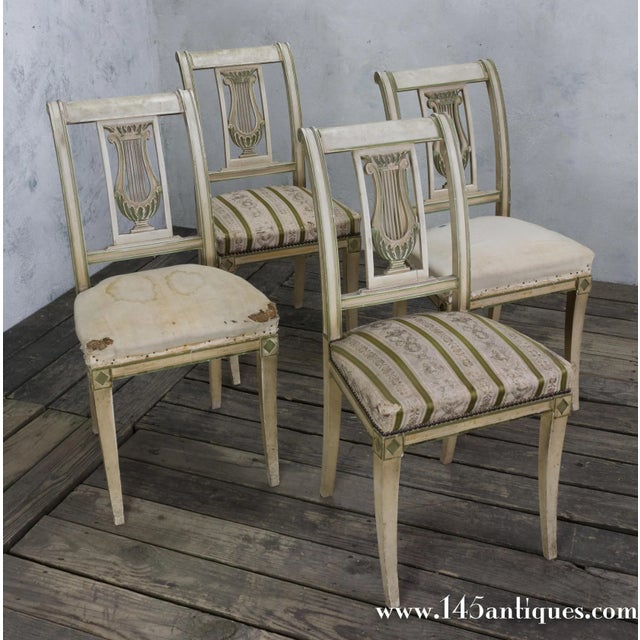 An elegant set of four French Neoclassical style dining chairs dating to circa 1920. Their refined painted frames feature...