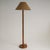 A vintage floor lamp with a beautifully turned, segmented wooden stem that highlights the natural grain of the wood,...