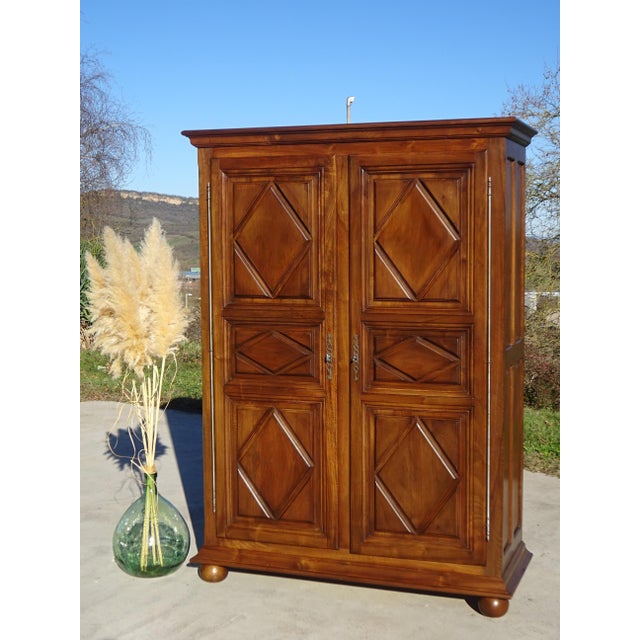 Medium-sized Louis XIII style wardrobe, with decorative diamond reliefs on the doors and ball feet on the front. High-...