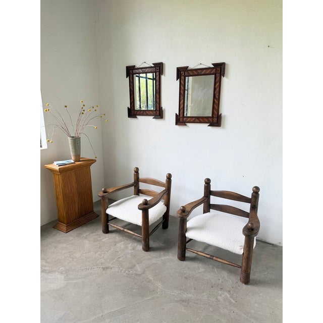 Antique pair of carved wooden mirrors inspired by tramp art, with their sculpted lines and details. We love the floral...