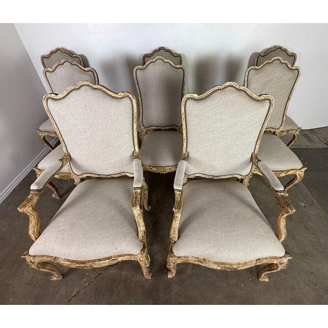 A beautiful and impressive set of eight French Louis XV–style carved dining chairs, including two armchairs (fauteuils)...