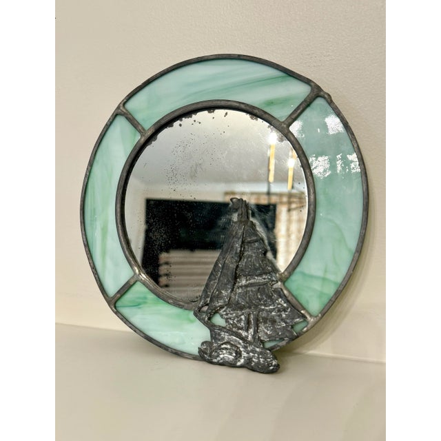 If your style has a nautical or coastal vibe, then consider this small stained glass accent mirror a "keeper" in your...