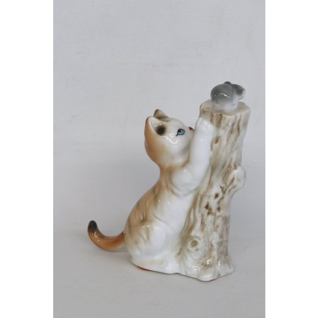 This charming Cat Chasing Mouse Figurine is made of bone china. This wonderful piece presents an expressive scene of a...