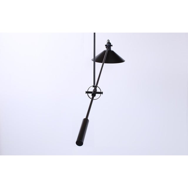 Large black counter balance light, created by Dutch modernist lighting company Anvia. This is an original light from the...
