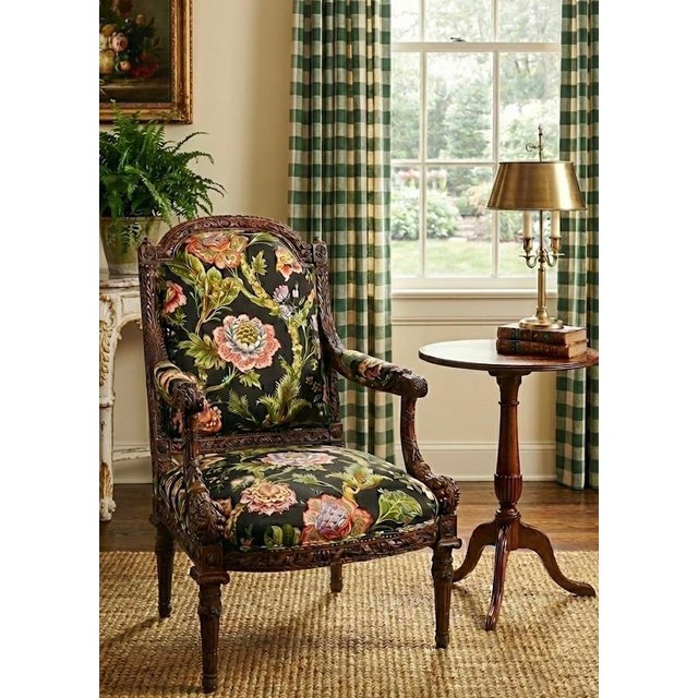 This is a late 20th century French Louis. XVI bergere chair in a vintage floral printed cotton fabric. The heavily carved...