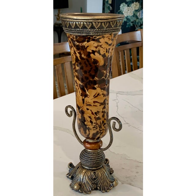 Tall mixed media vase with rich coloring in tan and deep brown. Handles and rim are detailed metalworking.