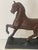 This antique cast metal horse statue dates to the early 20th century and was originally designed as a decorative clock...