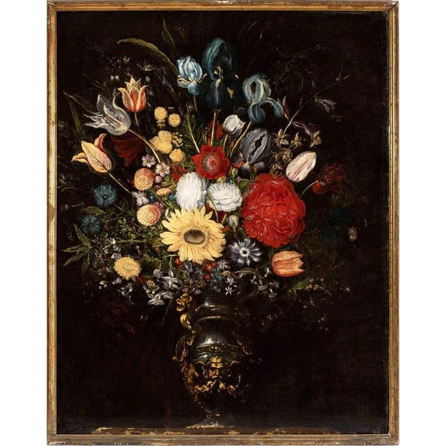 A magnificent oil on canvas representing a Vase of Flowers in a Metal Vase with a Mask, realized by an italian artist in...
