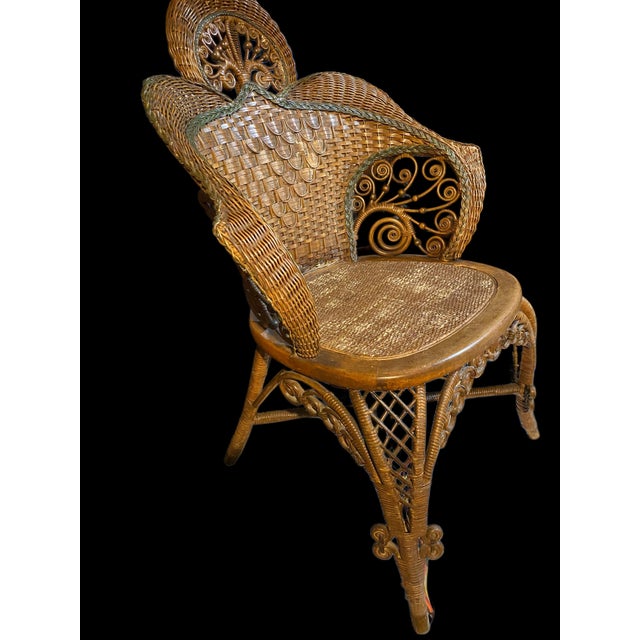 This is a highly decorative Victorian parlor chair, featuring: • Elaborate hand-woven scrollwork panels with bead accents...