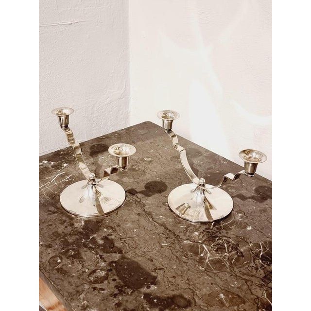 A pair of candle holders in stainless still by DANA DFA Denmark, mid-1900s. Beautiful Art Deco inspired design. with...