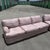 A striking Postmodern sectional sofa set consisting of two matching pieces upholstered in a soft mauve-pink geometric...