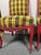 Padded chairs lacquered in red and aged black, retain the original vegetable hair padding and spring seat, are upholstered...