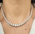 This exquisite diamond necklace features a stunning array of 105 round natural white diamonds, exuding a modern elegance....