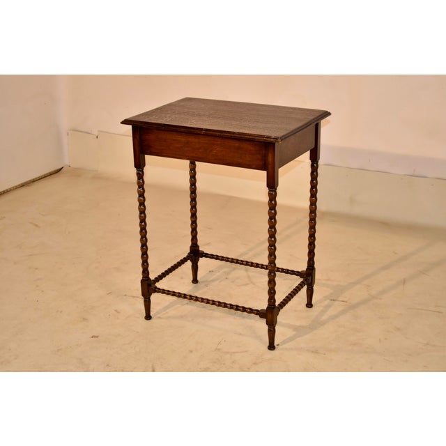 Edwardian oak side table from England, circa 1900. The top has lovely graining and has a beveled and molded edge,...