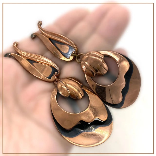 This is a pair of oversized organic style Renoir of California copper dangle clip-on earrings with artificially added dark...