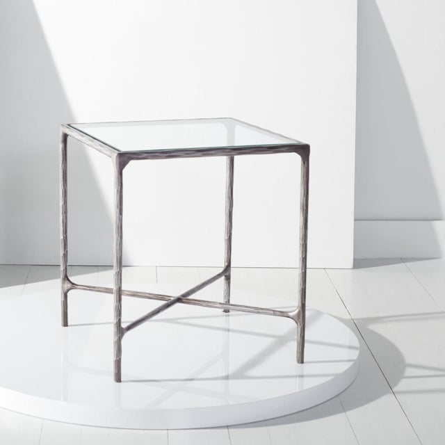 Enhance your living space with the Jessa forged metal square end table in silver. This striking piece combines the...