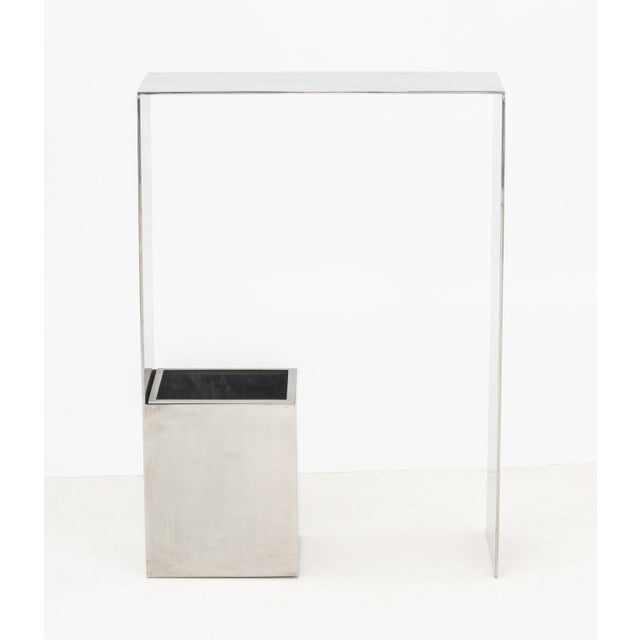 Contemporary Stainless Steel Console Table, with trash bin connected to the base. 33" H x 24" W x 10" D. Provenance: From...