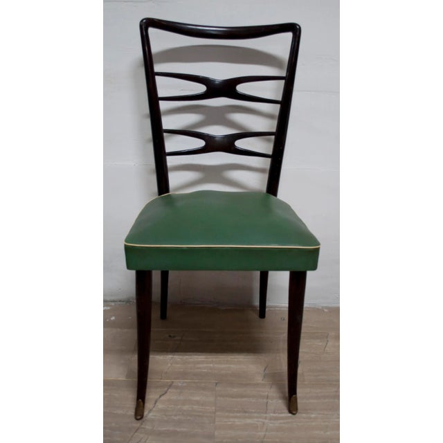 This set of four mid-century dining chairs was designed by Melchiorre Bega and retains its original upholstery in skai.