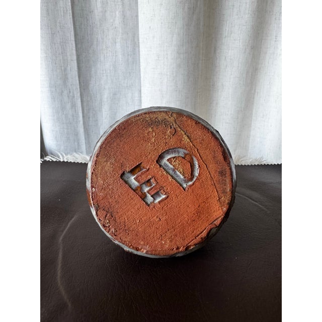 A beautiful mid-century modern studio pottery vase featuring a squat, bulbous lower body, a tapered neck, and deeply...