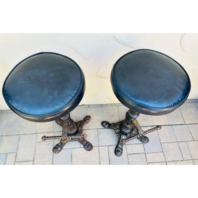 Antique cast iron swivel bar stools were designed and manufactured in the United States during the 1900s. The stools are...