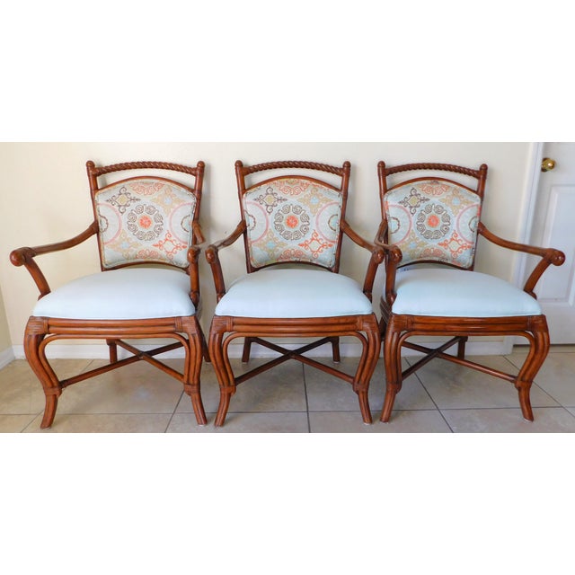 Gorgeous set of three Palecek rattan upholstered armchairs. Beautiful brown rattan base with barley twist design. Wrapped...