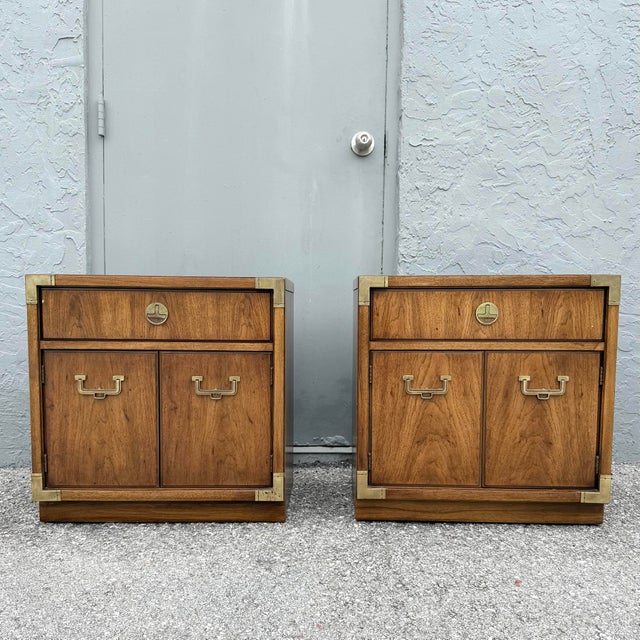 A handsome pair of vintage Huntley Campaign nightstands by Thomasville, showcasing the clean lines and refined detailing...