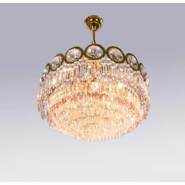 Elegant chandelier with a brass frame and swarovski crystals in clear and some with lavender lace amongst them. These...