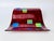 A bold postmodern wall sculpture in deep ruby-red fused glass. The rippling rectangular form is layered with iridescent...