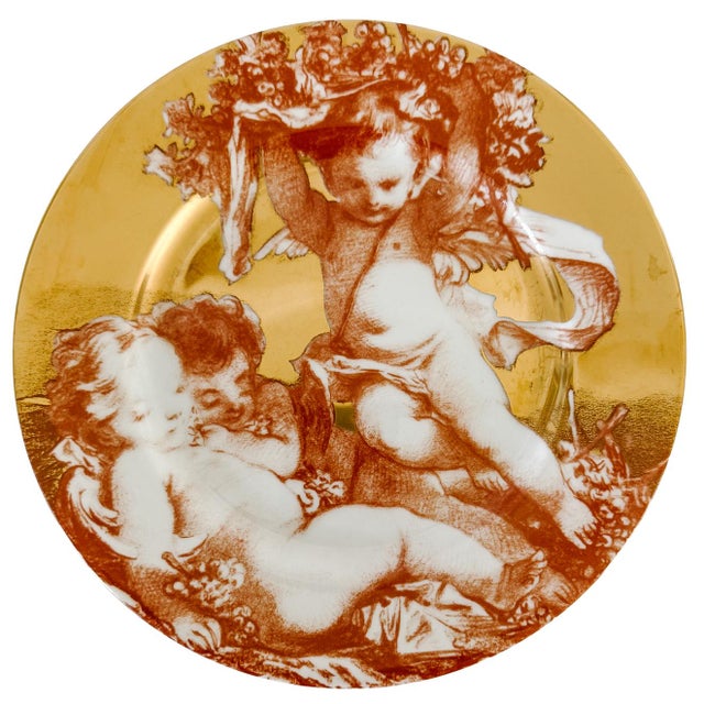 A rare set of twelve fine porcelain plates from the Fitz and Floyd Cherubini collection dated 1995. Each plate features a...