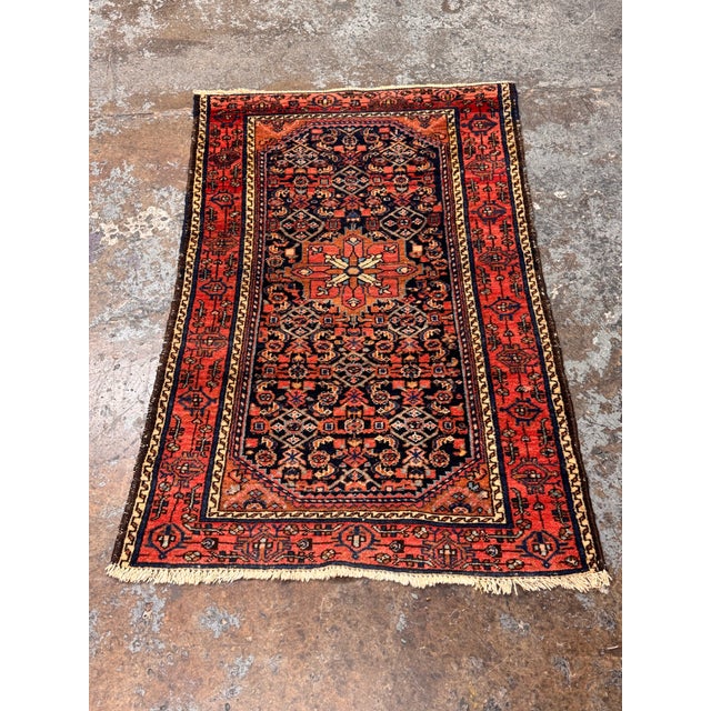 Design Plus Gallery presents a Vintage Hand-Knotted Persian-Style Wool Accent Rug. This rug has a red and navy field with...