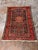 Design Plus Gallery presents a Vintage Hand-Knotted Persian-Style Wool Accent Rug. This rug has a red and navy field with...