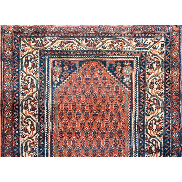 A wonderful early 20th century Persian Seraband runner with an all-over paisley patterned field against a crimson...