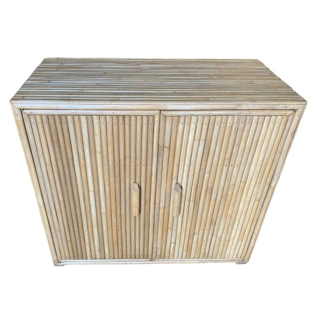 Vertically stacked rattan lowboy cabinet with a solid mahogany top. The cabinet features double doors and two adjustable...