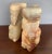 Nicely carved solid stone bookend pair in striated figured onyx or agate, midcentury circa 1970s. The pair depict Mexican...