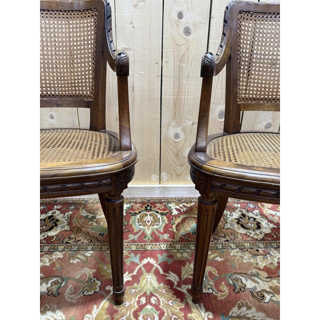 Beautiful pair of small Louis XVI style cane armchairs in solid walnut. An original and rare model due to its size and...