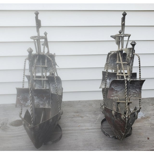 Pair of decorative hand forged iron ships. Good condition. Vintage items form the 1960s. Measures 12"W x 3.5"D x 12"H.