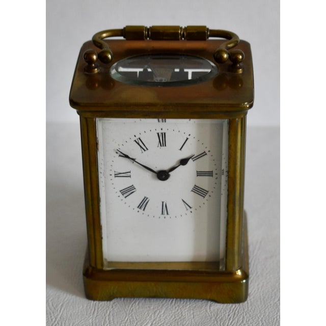 Antique (1920's) Carriage Clock has a Traditional Style. Brass, Handle, and Roman Numeral Face. The Measurements: 3"W x...
