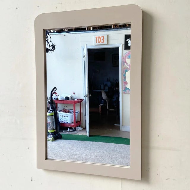Amazing vintage postmodern hanging mirror. Features a tan lacquer laminate with a waterfall top.