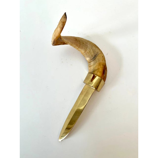 a stunning and large letter opener in brass with a horn handle. The piece is impressive and shines bright. A compliment to...