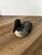 This is a hand-carved and hand-painted wooden common loon decoy sculpture with black-and-white checkered plumage and a red...
