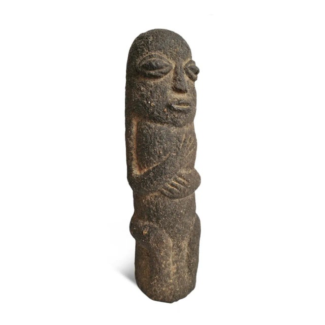 Antique small carved black stone figure from the Bamileke tribe of Cameroon. Simple oblong rounded shape with stylized...