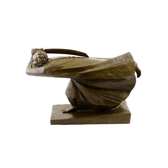 This bronze sculpture presents a draped figure in a powerful horizontal motion, with the head lowered and the body thrust...