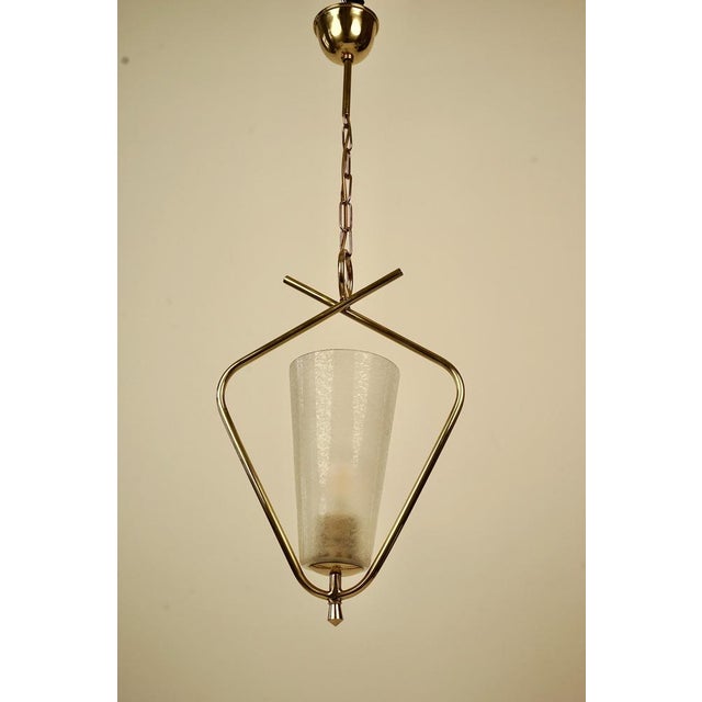 A beautiful pendant lamp from rupert nikoll from the 1950's. The brass on this lamp ,has been completely restored. The...