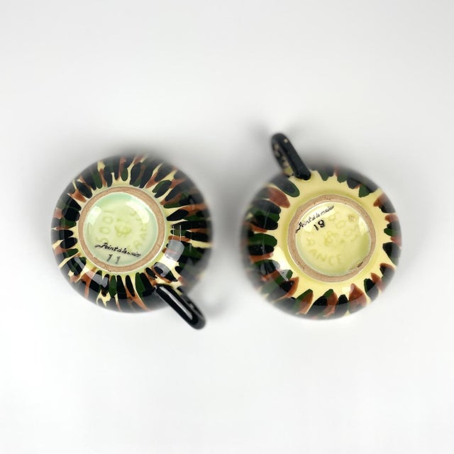 Two ceramic cups and saucers from the French manufacturer Saint-Clément. Hand-painted decoration Stamped mark Circa 60...