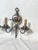 This refined pair of double-arm sconces features a sophisticated silver finish and intricately detailed wall mounts that...