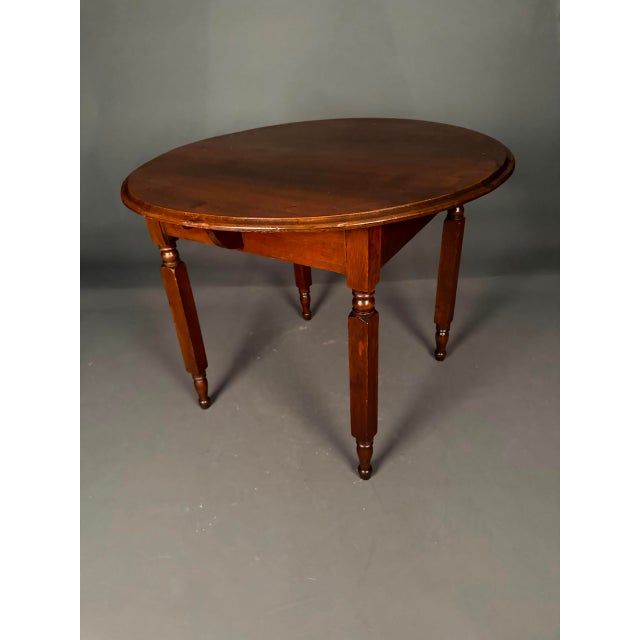 Charming late 19th-century American round dining or occasional table dating to circa 1890. Crafted from solid poplar wood...