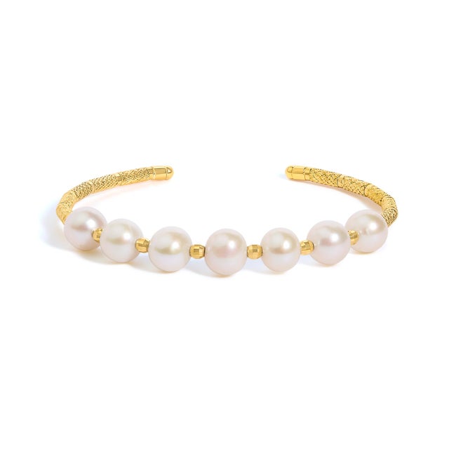Encircle your wrist with the timeless elegance of the 18 KT Yellow Gold Freshwater Pearl Cuff Bracelet, a quintessential...