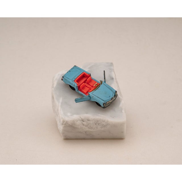 Original vintage die cast model of the mercedes benz 230 sl from siku, v229 series, mounted on a solid marble base. A...