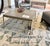 Hammered iron base in Champagne gold finish Concrete wave edge top - 1.5" - in dark grey -top is sealed 36" x 36" x 18" h...