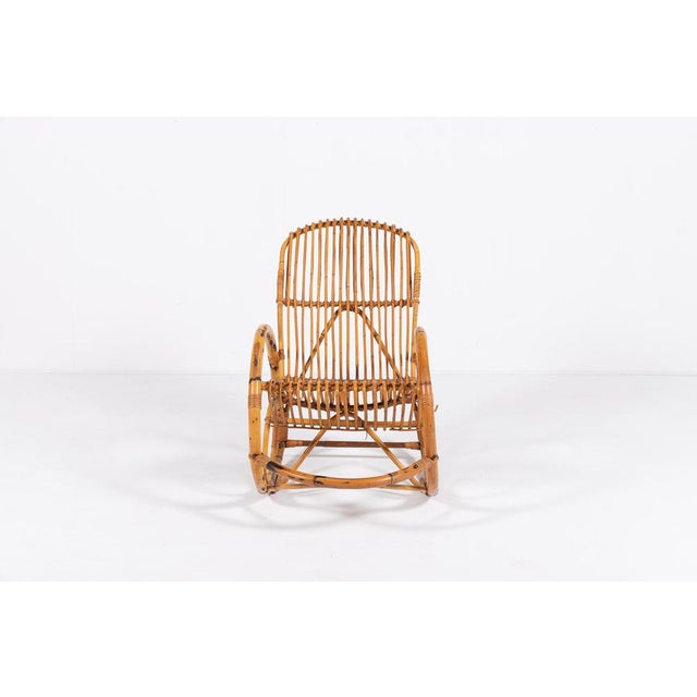Sculptural vintage rocking chair from 1960s. The chair features sculptural bamboo frame with a seat and backrest in...